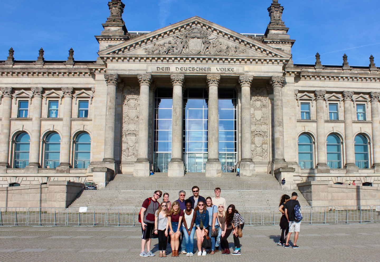 Student group posing in front of the Reichstag building in Berlin, Germany.
