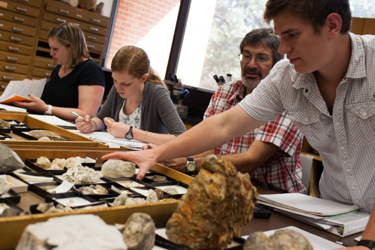 Professor and Students studying rocks