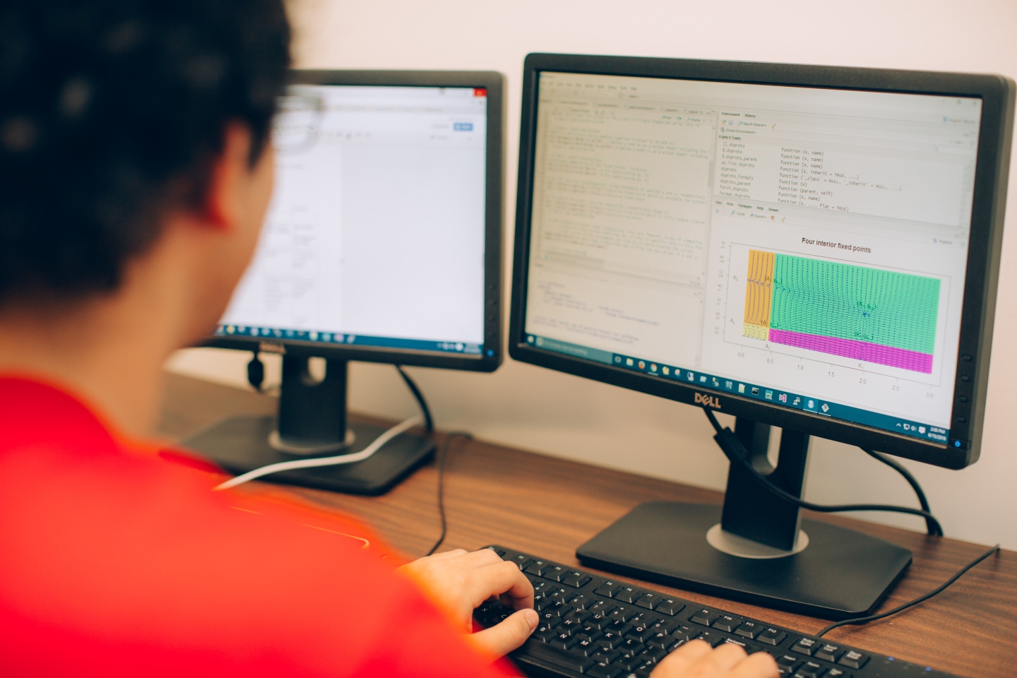 Student looks at code on a computer. 