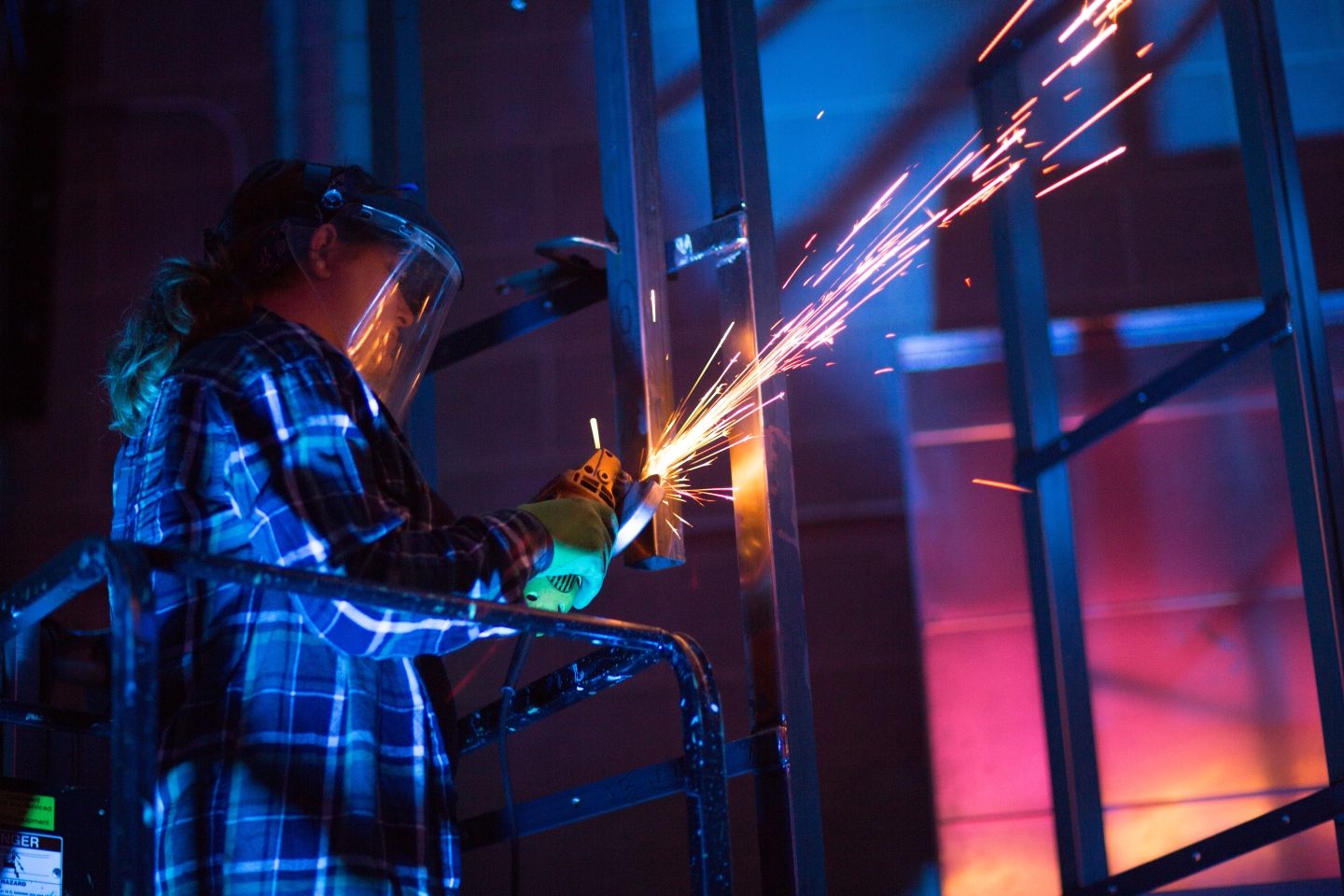 Sparks fly as a student helps build a stage set.