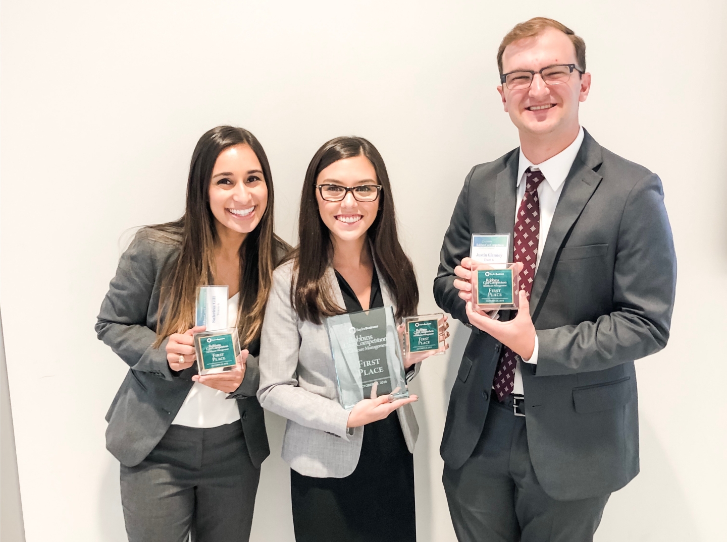 Sabrina, Andy, and Justin take first place at a case competition.