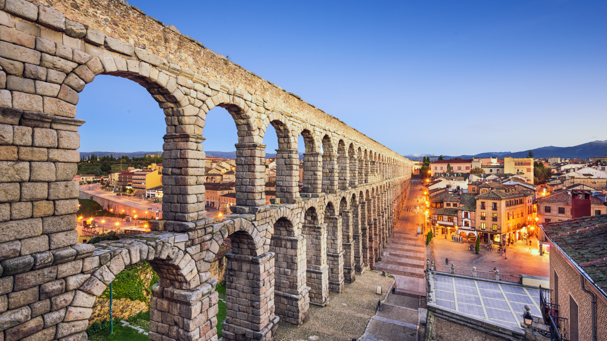 Sunset at the Aqueduct of Segovia, which was built by ancient Romans in Segovia, Spain