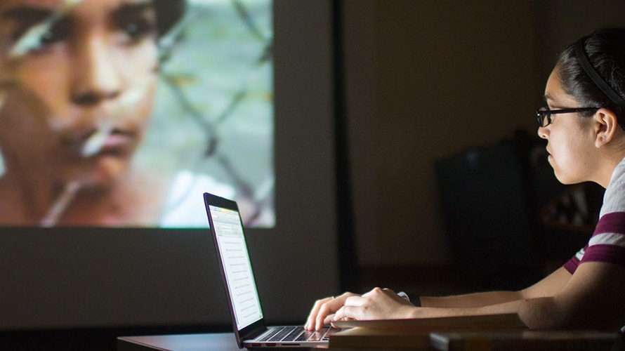 Student Megan Medrano uses her laptop while analyzing a film