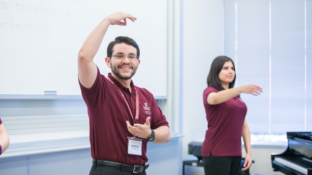 Two people doing hand movements