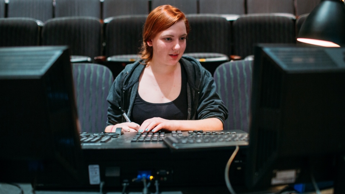 Woman working at theatre switchboard.