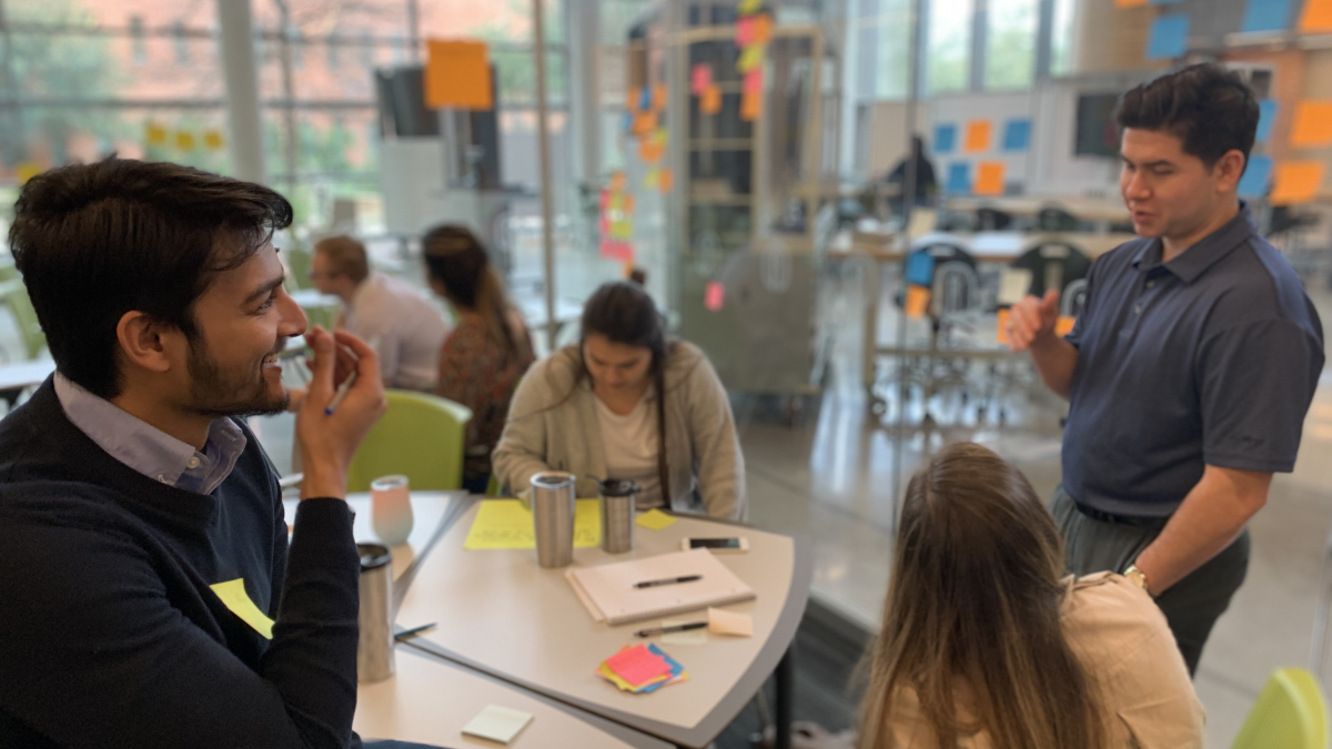 Students joyfully engage in a class excercise in the Trinity Innovation Room. 